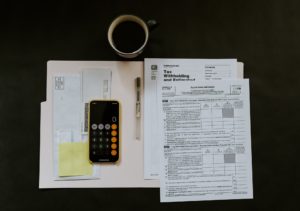 tax documents in a folder with a calculator
